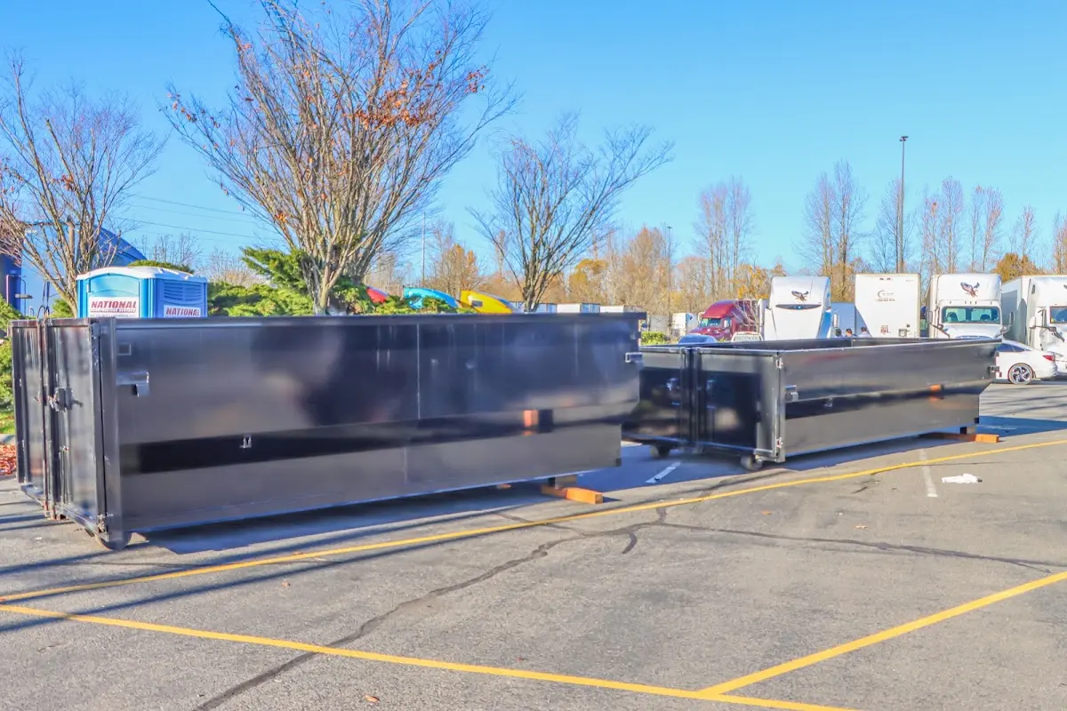 Professional dumpster rental service with roll-off container on residential driveway in North Madison